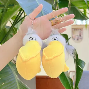 Detailed view of two cute pelican plush keychains with large yellow beaks in soft fabric
