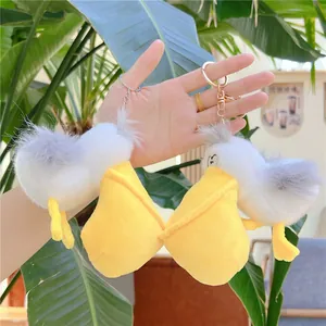 Cute plush pelican keychain with soft white fur and a large yellow beak for bags