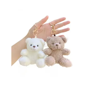 Curly teddy bear plush keychains in white and brown with gold lobster clasps
