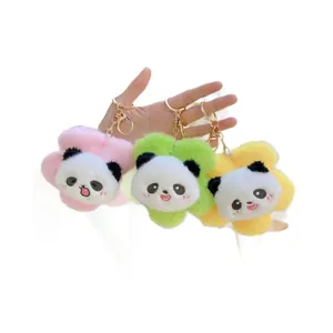 Three plush panda flower keychains in pink, green, and yellow soft fabric with gold rings