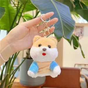 Detail of cute Shiba Inu plush keychain wearing blue and yellow hoodie with metal clasp