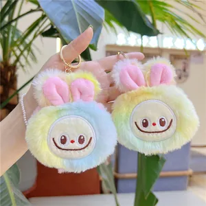 Close-up of colorful plush doll pendant with soft fur and golden keychain ring