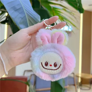 Close-up of macaron gradient plush rabbit keychain with gold hardware and pearl chain