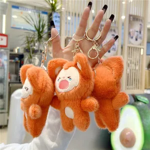 Detail of cute orange plush fox keychains showing smiling faces and soft fur texture