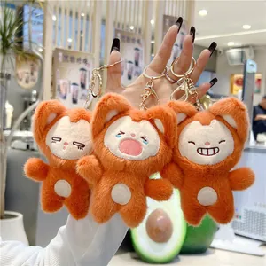 Close-up of three cute plush fox keychains with expressive faces and gold metal rings