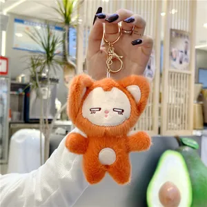 Detailed macro view of orange plush fox pendant with golden metal clasp and key ring
