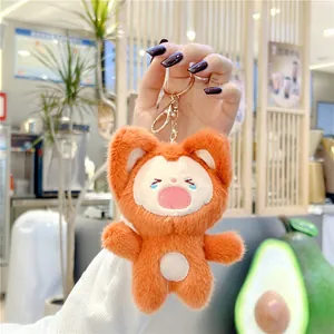 Close-up of cute orange plush fox keychain with fluffy texture and golden metal clasp
