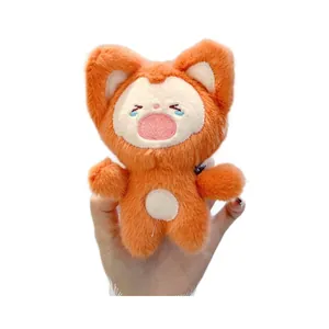 Cute orange cartoon fox plush keychain held in hand, soft stuffed toy for backpack charm