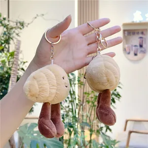 Close-up of cute plush croissant dolls with metal lobster clasps for bags and keys