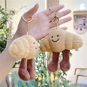 Cute croissant plush keychain charms with embroidered faces and metal clasp for bags