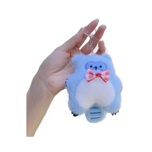 Cute light blue plush raccoon keychain with a soft striped bow and fluffy tail hanging