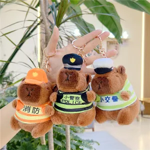Detail shot of three plush capybara keychains dressed as firefighter and police officers