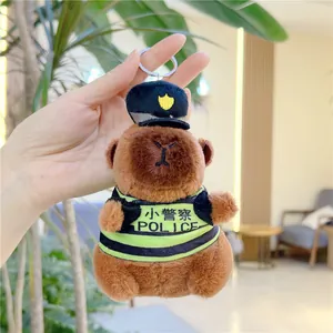 Detail of capybara plush keychain wearing blue police hat and green uniform vest
