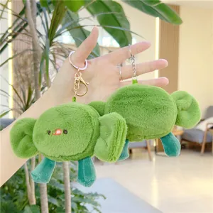 Close-up of cute plush green candy-shaped keychains with vivid facial expressions