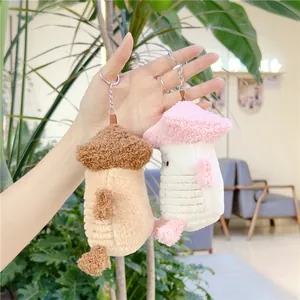 Detail of cute mushroom plush charms in brown and pink with silver metal keychains