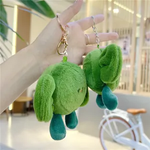 Close-up of green plush seaweed knots keychain with metallic rings and soft texture