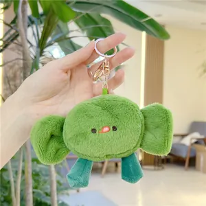 Cute green plush elephant keychain with long ears and tongue out for bags