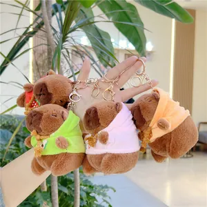 Cute Capybara plush keychains in colorful hoodies with strawberry and avocado details