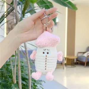 Close-up of cute pink plush mushroom keychain with fluffy sherpa texture and silver ring