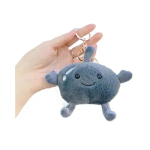 Cute grey frozen pear plush keychain with embroidered smile held in hand on white background