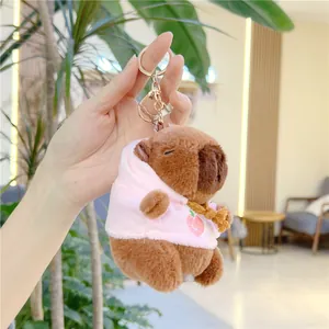 Detailed plush capybara keychain with pink peach hoodie and golden metal lobster clasp