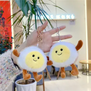 Close-up of cute poached egg plush keychain with smiling face and soft fluffy texture