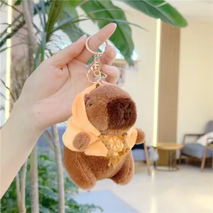 Close-up of a Capybara plush keychain wearing a yellow hoodie with an orange print