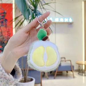 Detail shot of a plush durian fruit keychain with soft faux fur and metal ring