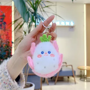 Detail of creative dragon fruit plush keychain with cute face and pink fur texture