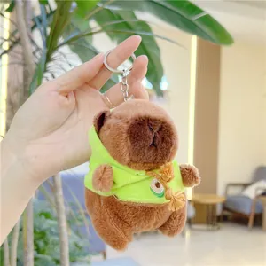 Close-up of a brown capybara plush keychain wearing a green hoodie with avocado detail