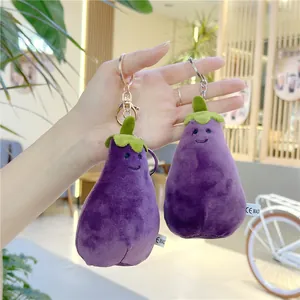 Close-up of purple plush eggplant pendants with embroidered faces and CE safety tags