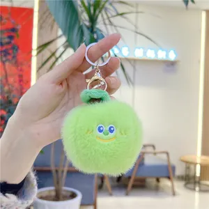 Detail of green apple plush keychain with cute embroidery and silver lobster clasp