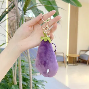 Detailed macro shot of purple plush eggplant pendant with gold metal clasp and white label