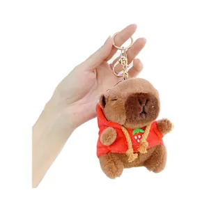 Capybara plush keychain wearing a red strawberry hoodie with a gold lobster clasp