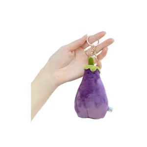 Funny purple eggplant plush keychain with a cute smiling face and gold metal clasp