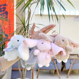 Cute plush lop-eared rabbit keychains in four colors with floral bows and gold lobster clasps