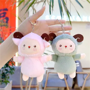 Close-up of cute plush lamb keychains in pink and green with curved horns and soft fur