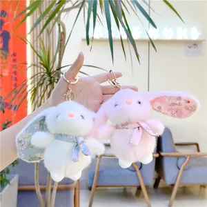 Cute white and pink plush bunny keychains with floral ear lining and gold metal rings