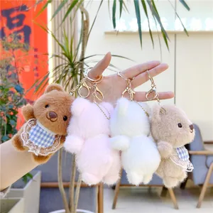 Close-up of four colorful plush teddy bear keychains with gold metal lobster clasps