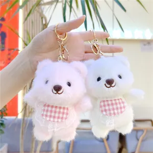 Cute plush bear keychains in pink and white with lace bibs and gold metal hooks