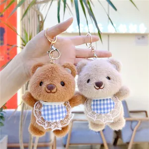 Detailed shot of plush bear keychains with lace bibs and gold metal lobster clasps