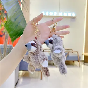 Cute fluffy sloth plush keychains in brown and grey with golden metal hooks and soft fur