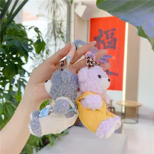 Detail shot of cute plush bear pendants in grey and purple corduroy overalls with hooks