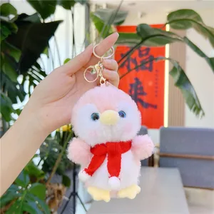 Cute pink plush penguin keychain with red scarf and gold metal clasp for bags
