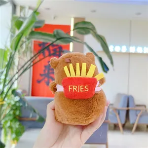 Close-up of a plush capybara wearing a red fries backpack with FRIES embroidery detail