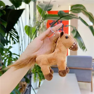 Macro detail of brown plush pony keychain with soft synthetic fur and leather bridle