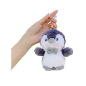 Cute gray and white plush penguin keychain with soft fur and golden metal ring