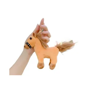 Plush horse keychain toy in light orange with brown mane and golden metal hook