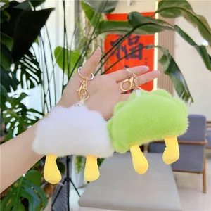 Plush sleepy moon dumpling keychain in white and green with yellow feet for backpacks