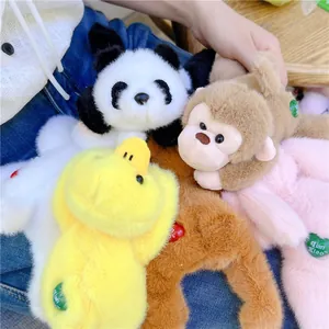 Detail of plush animal figures including panda and monkey with soft texture and brand tags